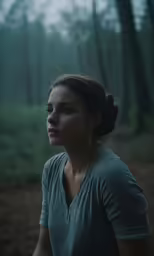 woman with grey t - shirt in the woods, looking out