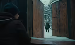 a woman walking through some wooden doors to her destination