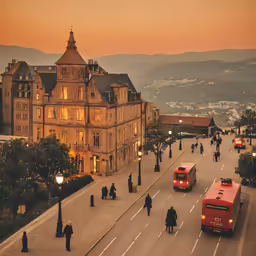 a street in the evening with a couple of red buses