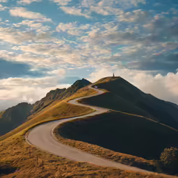 there is a curved road going up a hill