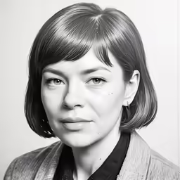 a woman with medium hair and large brows is dressed in a suit