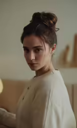 a girl wearing a white sweater with a bow tie