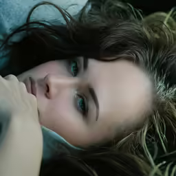 a close up photo of a woman lying down