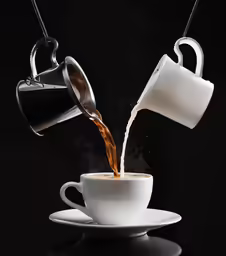 a cup filled with liquid being poured out of it