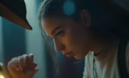 a girl staring at another young person in a strange pose