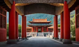 a pagoda with stone pillars on the walkway next to it