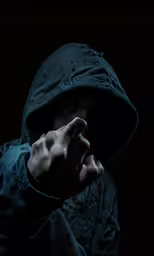 the person in the hooded jacket is making a sign