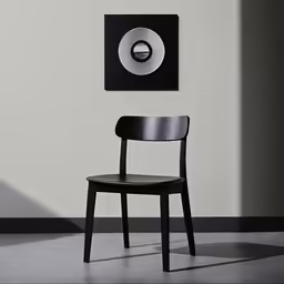 a chair with a black seat next to an empty table