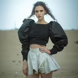 a young woman wearing shorts and a black top