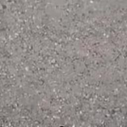 an old cellphone sitting on the ground near a pair of shoes