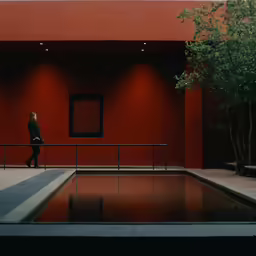 a woman is walking on a path near some water