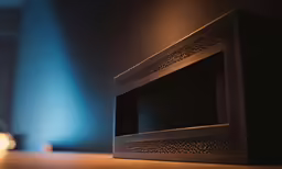 there is a microwave in the corner with blue light