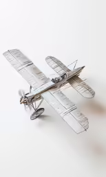 an old propeller biplane that is white