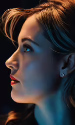 a woman with her eyes closed and wearing blue earrings