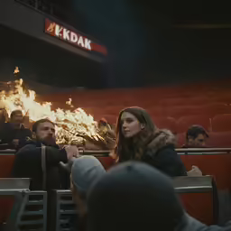 people are in seats and sitting around fire