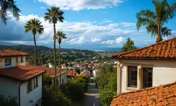 a street with trees and buildings near some mountains