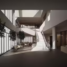 a large open room with some stairs and seating