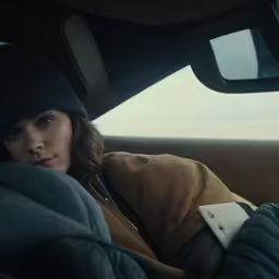 a woman sitting in the back seat of a car