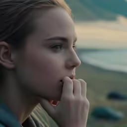 a close up image of a woman leaning her elbows in front of her face