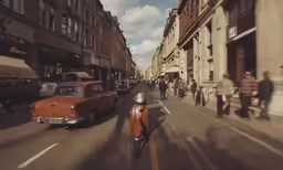 a motor scooter is traveling down a street