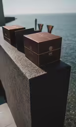 three boxes on the cement ledge of an overlook