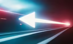 an arrow on a long highway going through the night