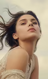 a woman in a dress with a hair blowing in the wind
