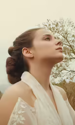 a woman wearing a white wedding dress in the middle of a field