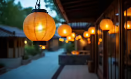 a walkway lined with yellow lights at dusk