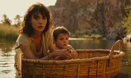 a woman and child sitting in a basket in water