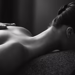 the back of a naked woman on a chair
