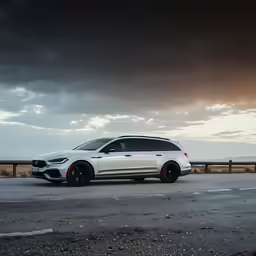 white bmw x5 driving on a stormy day