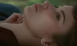 a close up of a person laying in the grass