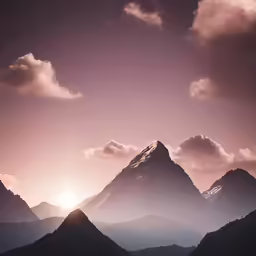 the sun shines down on the mountains from below