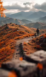 man standing on top of a mountain looking over at a valley