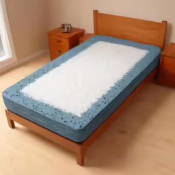 a bed with a mattress in it on a wood floor
