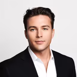 an attractive man wearing a suit and white shirt
