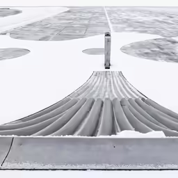 snow covered airport with walkways and runway