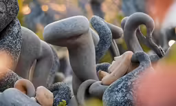 a photo of some statues in a park
