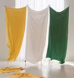 several folded towels with a white frame and three colors on it