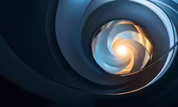 a spiral shaped space is lit by a small light bulb