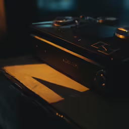 there is a video camera and remote control sitting on a table