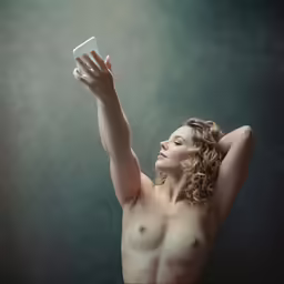 nude girl looking up with a very large breast