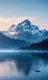a mountain rising over a body of water near a forest