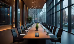 a long table with a centerpiece set up for a conference