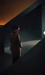 a woman is looking down at her face, the light from her lamp is coming on behind her