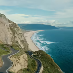 a curved road next to the water and a mountain