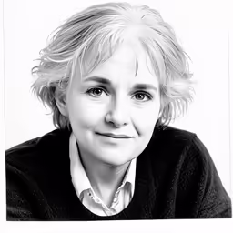 an older woman is sitting in black and white