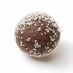 a close up of a chocolate pastry with white sprinkles