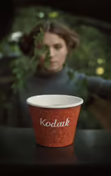 a close up of a person holding onto a drink cup
